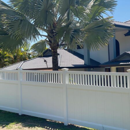 Mary PVC fence gallery privacy fence beside a palm-lined home by Queensland Fencing Specialists